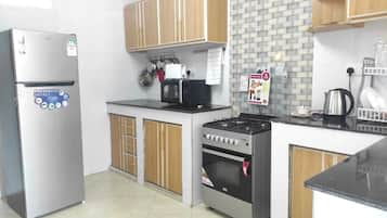 Fridge, microwave, toaster, dining tables