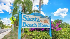 A sign for Siesta Beach House with a clear pedestrian crossing sign and a number 5950. - A Perfect Get-Away! Newly Remodeled Home On Siesta Key! (Siesta Key)