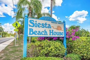 A sign for Siesta Beach House with a clear pedestrian crossing sign and a number 5950. - A Perfect Get-Away! Newly Remodeled Home On Siesta Key! (Siesta Key)