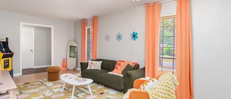 Living room with vibrant ambience and arcade game