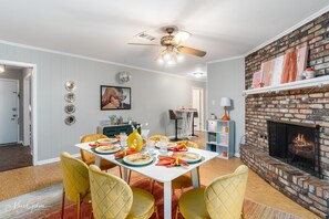 A charming dining area for six nestled beside a cozy fireplace - Backyard - Games - Vibrant (Shreveport)