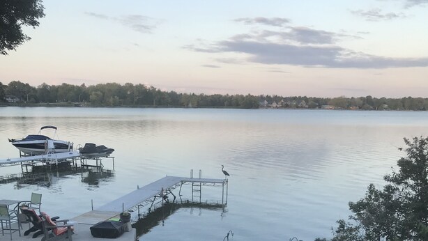 A lakeside patio with a dock, a table, and chairs. - Lake front bachelor 
Close to all amenities casino Rama 
Ski hills  (Orillia)