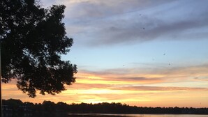 A lakeside view with a dock, boats, and a grassy area with outdoor seating. - Lake front bachelor 
Close to all amenities casino Rama 
Ski hills  (Orillia)