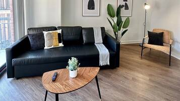 Deluxe Apartment | Living area | 50-inch Smart TV with cable channels