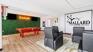 A billiards room with a pool table, green wall, and a sign for 'The Mallard Hotel'. - The Mallard Hotel (Copperhill)