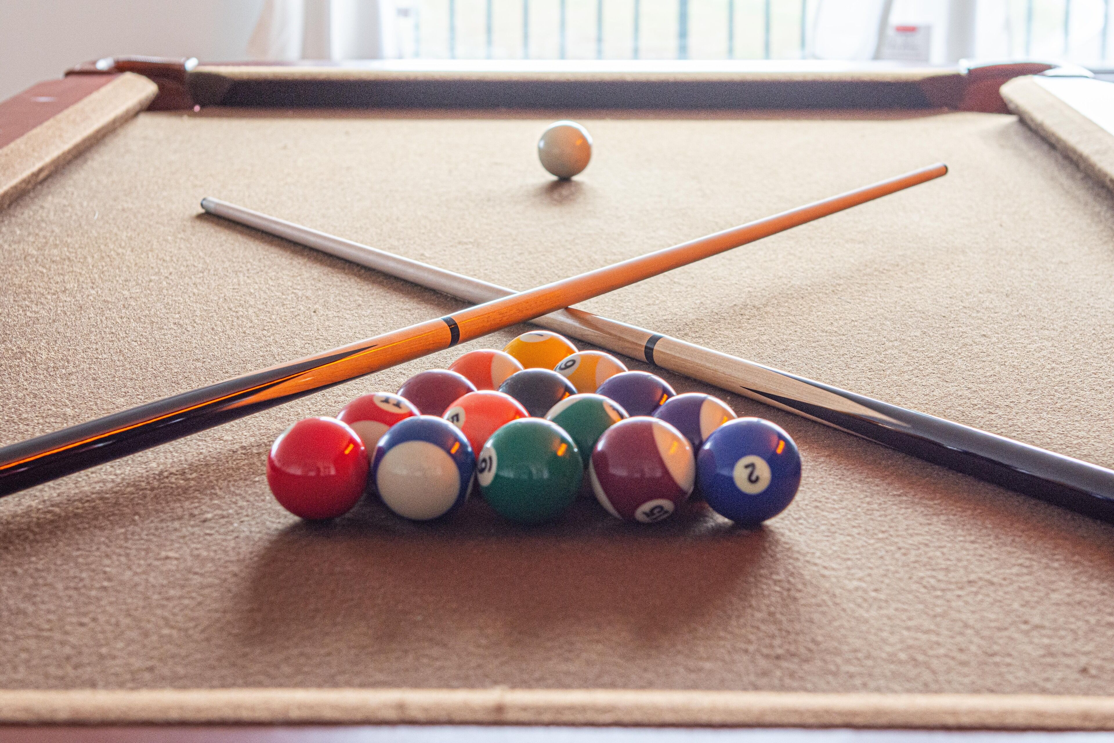 Ein Billardtisch mit Billardkugeln und Spielstöcken.