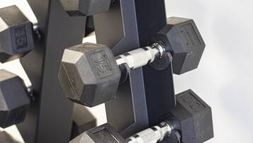 A close-up of a dumbbell rack with multiple weights.