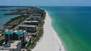 A coastal hotel with multiple high-rise buildings, a beachfront, and a clear view of the ocean. - BEACH VACATION ON BEAUTIFUL SAND KEY CLEARWATER 3BR w/ Private Beach Access
(Clearwater)
