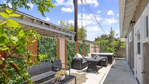 A patio area with outdoor furniture, a hot tub, and a covered seating area. - Stylist Home In Convenient  Location New Listing Special Book Now! (Temple City)