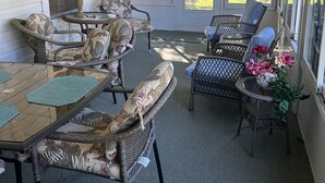 A covered patio with wicker furniture, a ceiling fan, and a view of the neighborhood. - The Villages
Lake Sumpter
Most desirable area 
Golf, pools and music every night (The Villages)