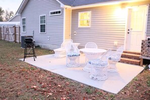 A house with a patio area featuring outdoor furniture.