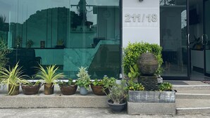 A building with a sign reading "Piraya Residence" and the address "211/18". - De Piraya Residence (Mai Khao)