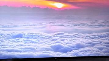A sunset over a sea of clouds with a flat horizon.