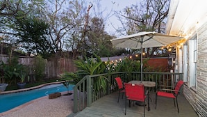 A wooden deck with a pool, surrounded by plants and a wooden fence. - 3BR The Poseidon! Aquatic Dream Pool in Montrose! (Houston)