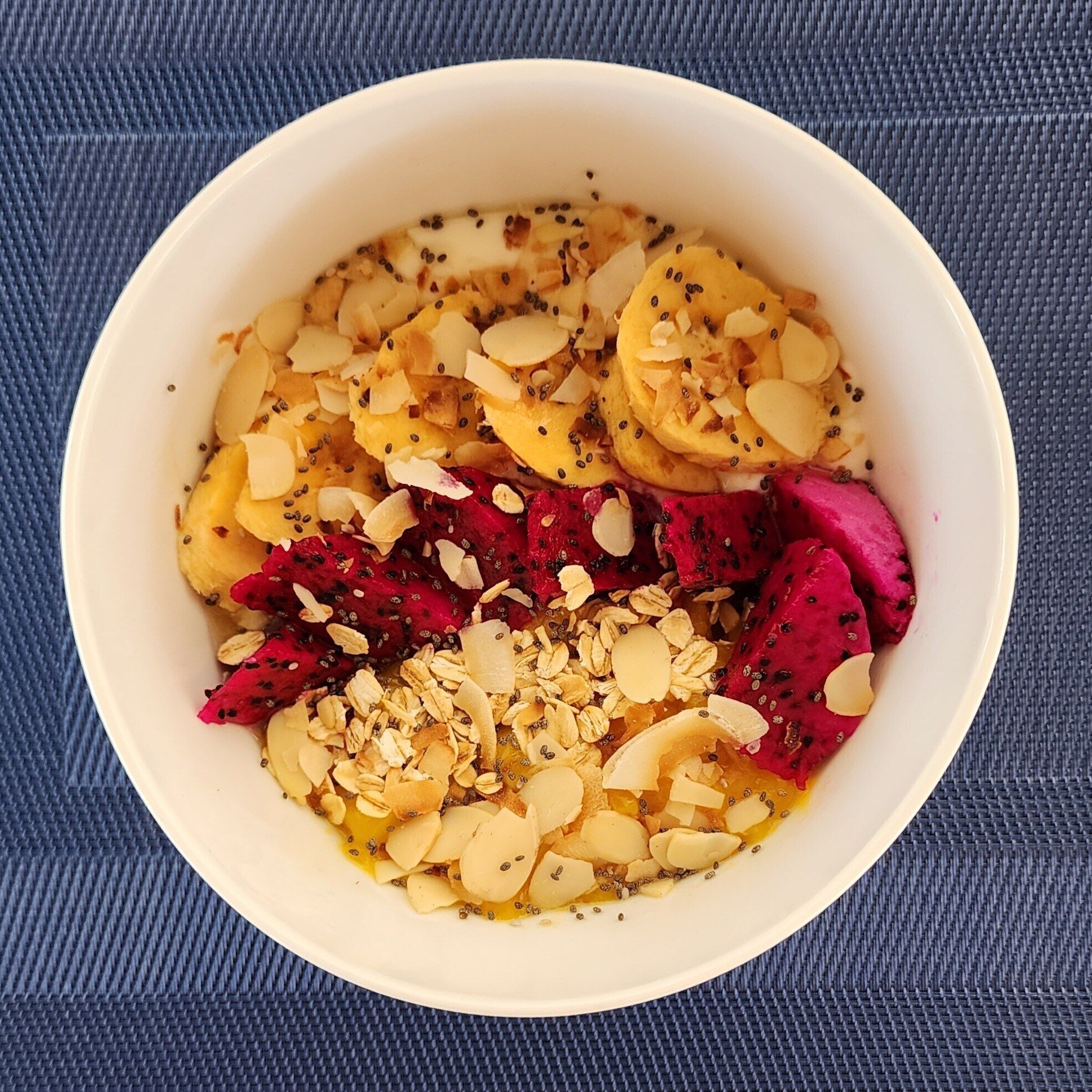 A bowl of food with various toppings.