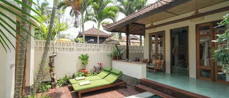 A poolside area with a lounge chair and a small pool.