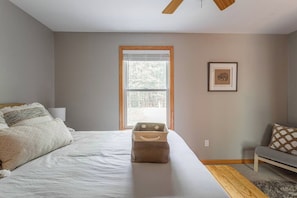 A bedroom with a bed, a window, a framed picture on the wall, and a bench. - Dee Grove Retreat | Game Area | Open Concept | 4 BDR Close to Skiiing, Lake (Albrightsville)