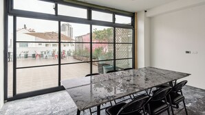 A modern room with a large glass door leading to an outdoor patio. - SATURN HOTEL (Taichung)