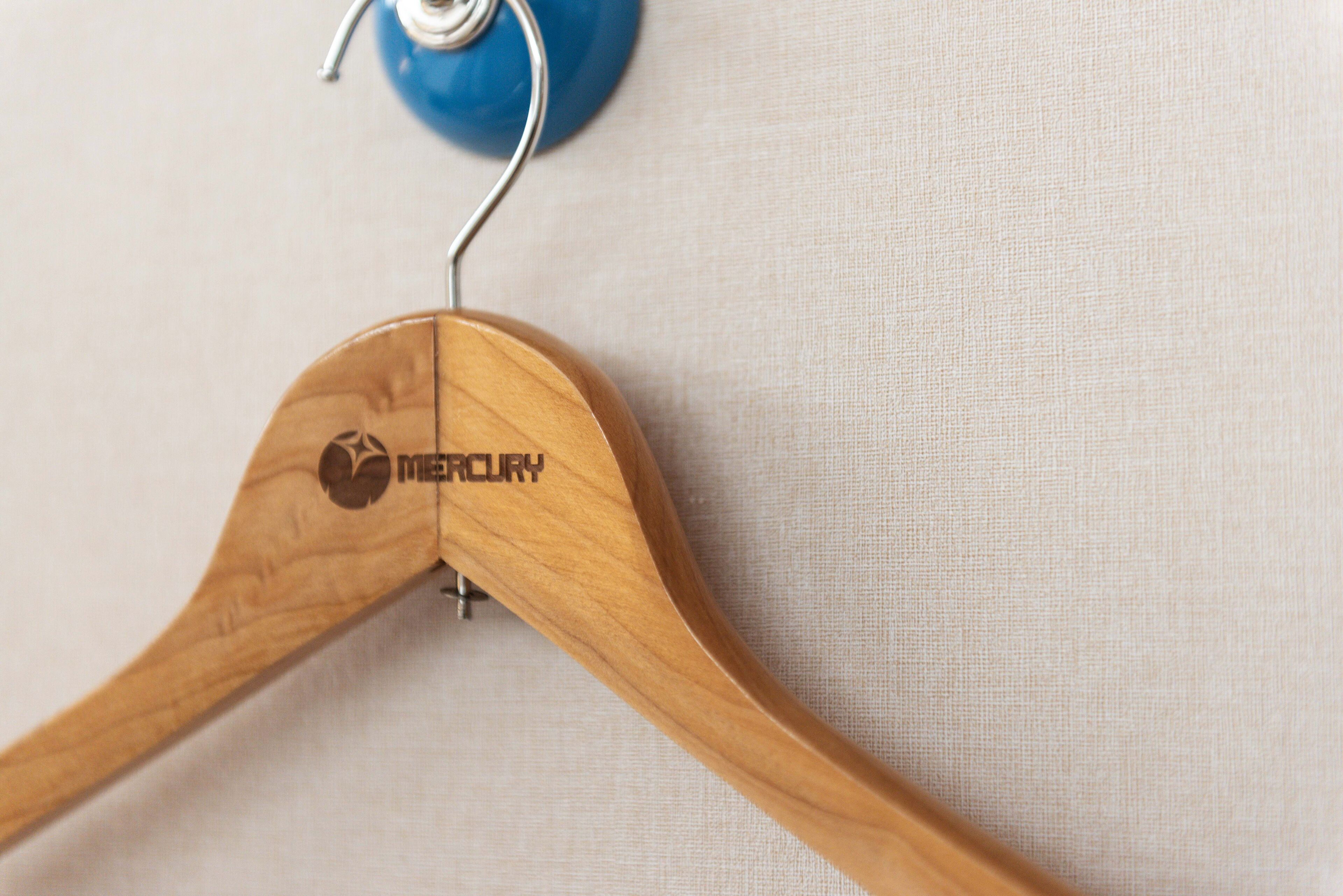 A wooden hanger with the brand name "Mercury" visible.