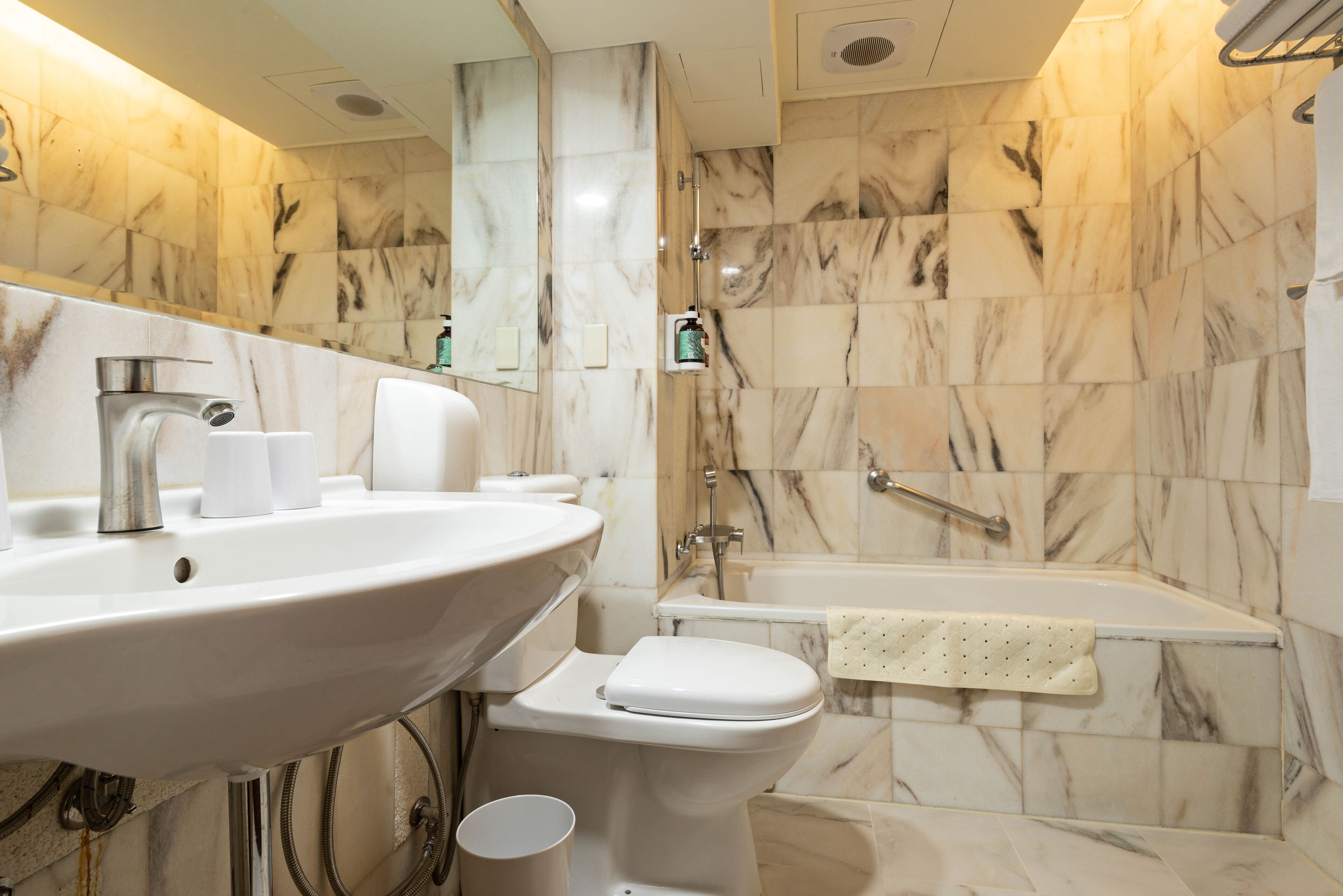 A bathroom with a sink, toilet, and bathtub.