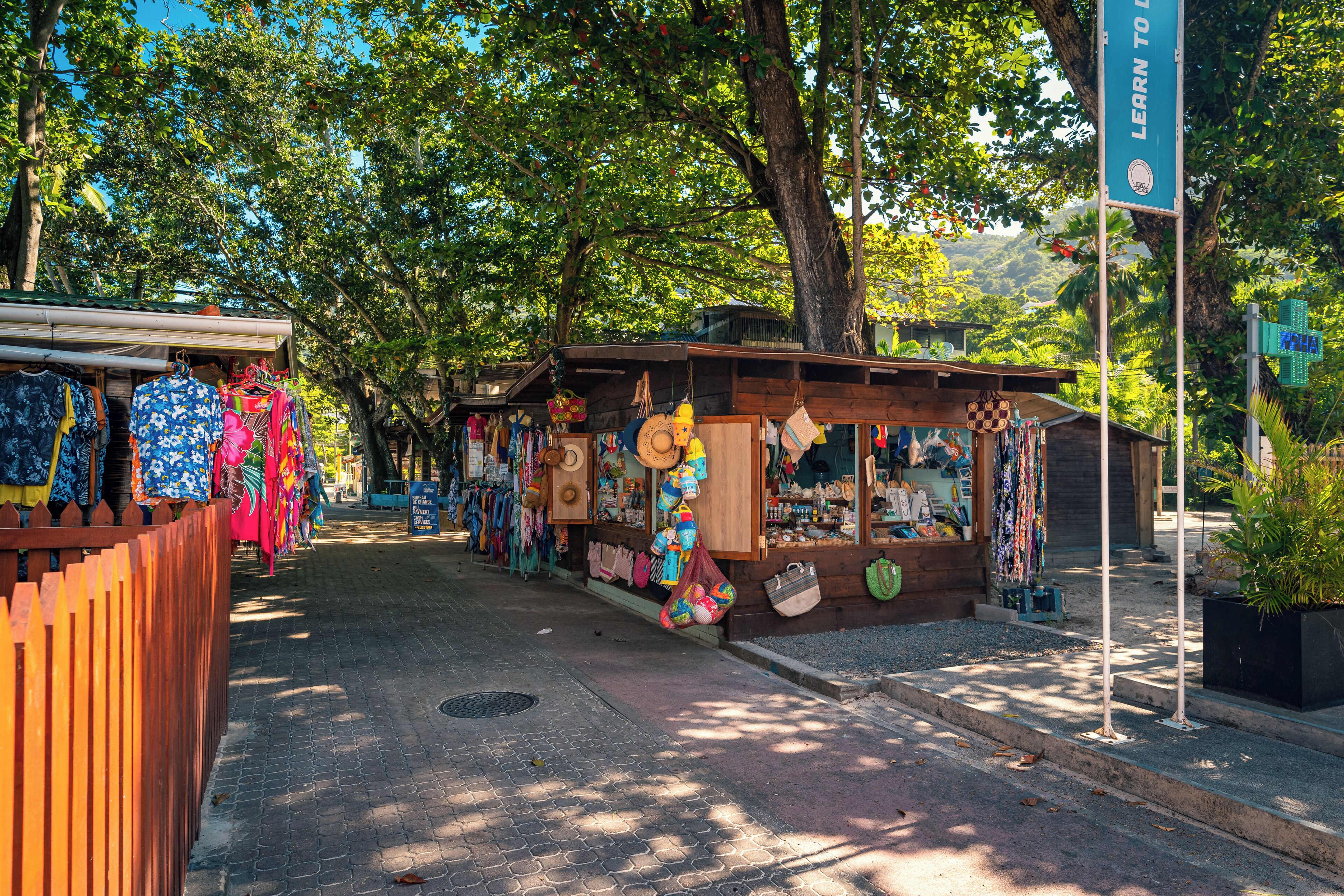 A street with outdoor stalls selling various items.