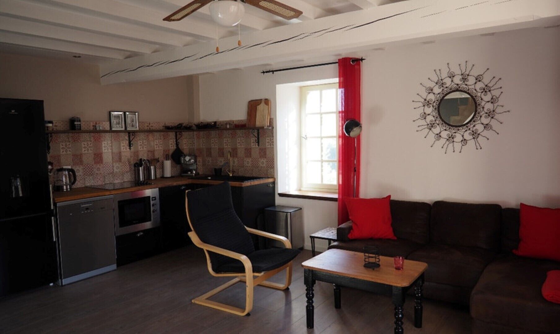 A compact living space with a kitchenette, a dining area, and a seating area.