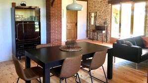 A dining area with a dark wooden table, four chairs, and a decorative centerpiece.