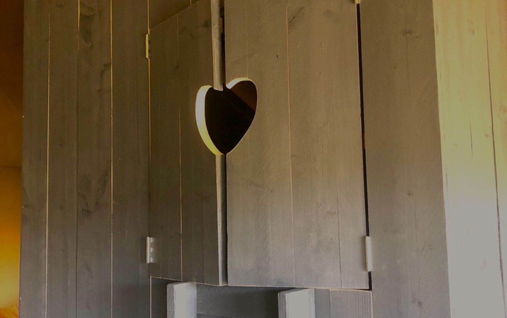 A wooden wall with a heart-shaped cutout.
