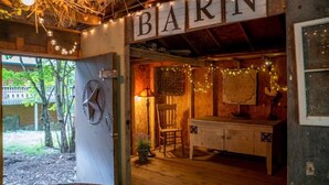 A rustic barn-style interior with a wooden bench, a table, and string lights. - Spring Brook Mountain Retreat + Hot Tub +Sauna+ Fire Pit (Mars Hill)