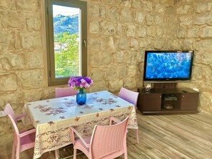 Premium Apartment, 1 Bedroom, Kitchen, Mountain View | Living area | 55-inch LED TV with satellite channels