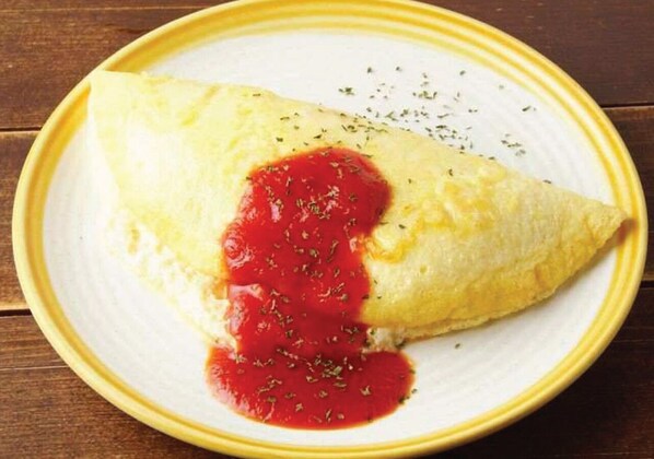 A plate with a folded omelette and red sauce. - The Ngam Kho Resort (Ko Kood)
