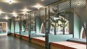 A modern interior with seating areas, wooden benches, and a patterned floor. - tent Mojito Suites (Calvia)