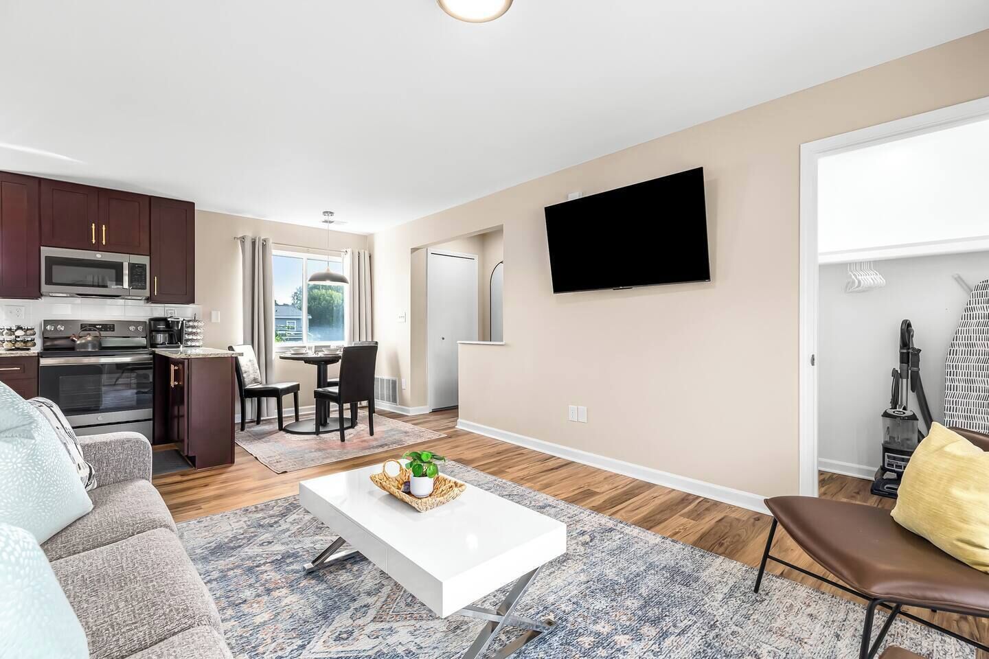 A modern apartment with a kitchen, dining area, and living room.
