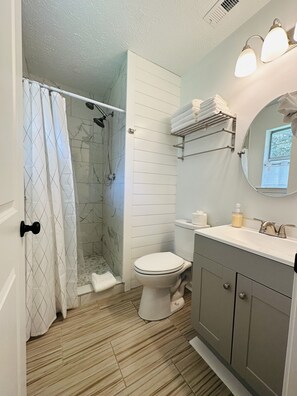Shower, hair dryer, towels, toilet paper