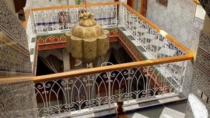 A multi-level interior with ornate tile work, a central fountain, and a staircase with decorative railings. - Riad Mahjouba Marrakech & SPA (Marrakech)