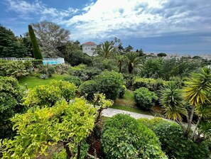 Escape to a serene garden oasis with lush greenery and a picturesque view.