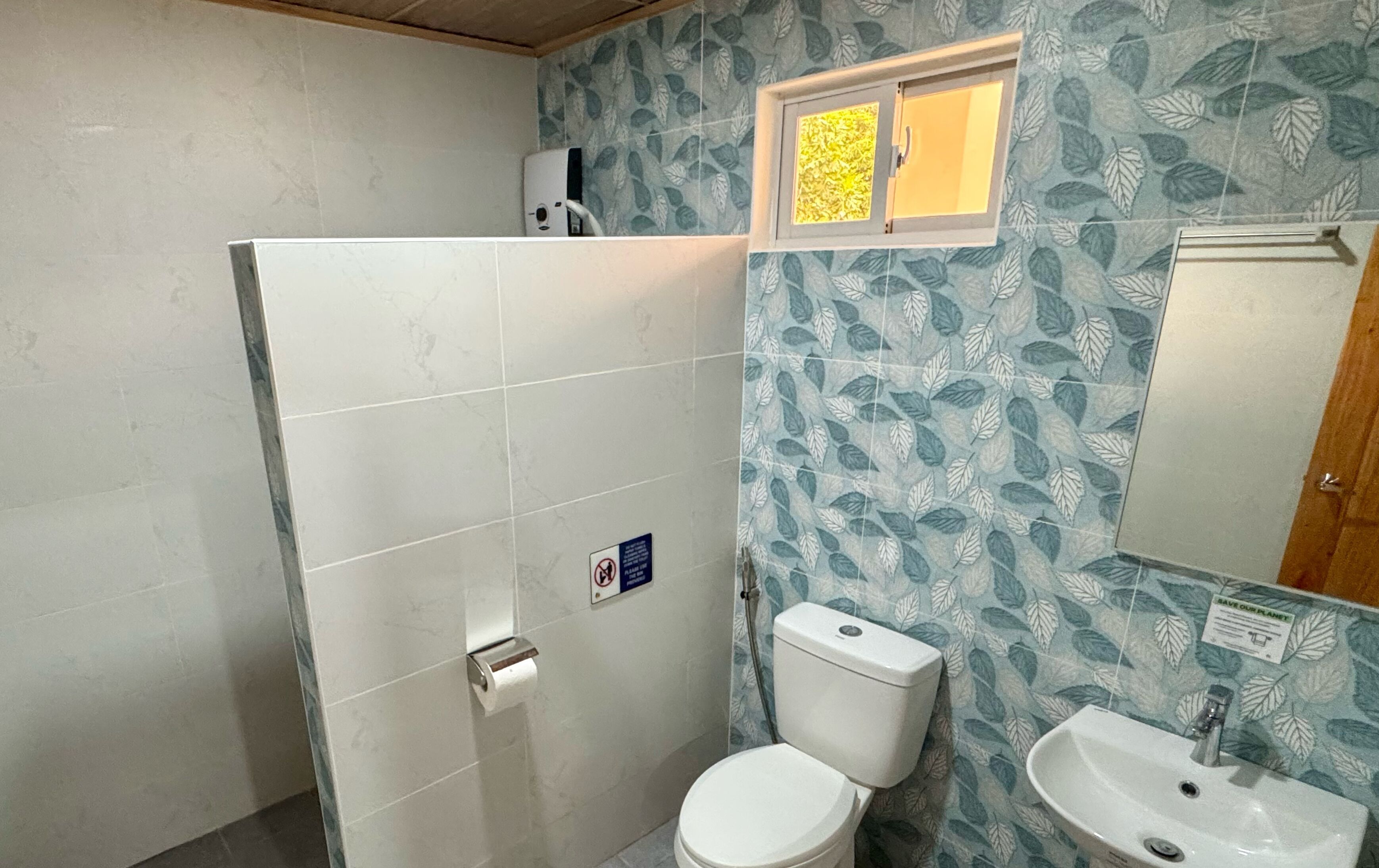 A bathroom with a toilet, sink, and shower.