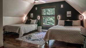 A bedroom with two beds, a ceiling fan, a window with a view of trees, and wall-mounted lights. - Modern, Sauna, Near Whiteface/Lake Placid, Dogs, Mountain Views (Wilmington)