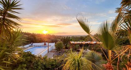 Hidden villa with pool and sea views, located in a green area.