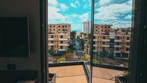 A balcony with a view of residential buildings and a clear sky. - La Onda Hotel (Durrës)
