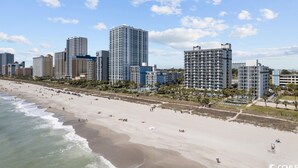 A coastal cityscape with a sandy beach and high-rise buildings. - Enjoy the Breathtaking View from Your Private Oceanfront Balcony (Myrtle Beach)