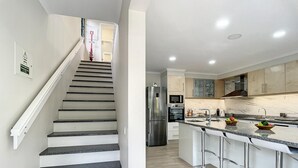 A modern kitchen with a stainless steel refrigerator, a microwave, and a built-in oven. - Solarium Villa by Atlantic Holiday (Machico)