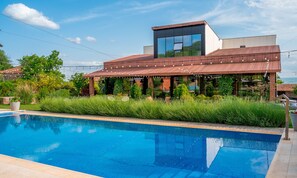 A modern building with a pool in front.