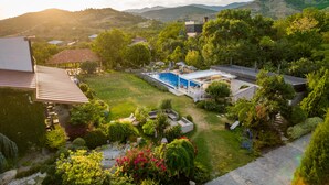 A residential property with a swimming pool, a covered patio, and a well-maintained garden. - Giuaani Winery (Sagarejo)
