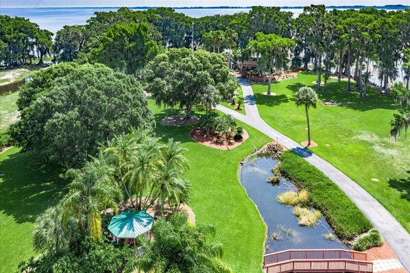 A well-maintained golf course with a pond, a bridge, and a gazebo. - Windy Point Estate - On Lake Istokpoga-5bdr. 5 1/2bath 7 beds. Amazing grounds (Lake Placid)