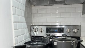 A kitchen with a stainless steel stove, a microwave, and a built-in oven.