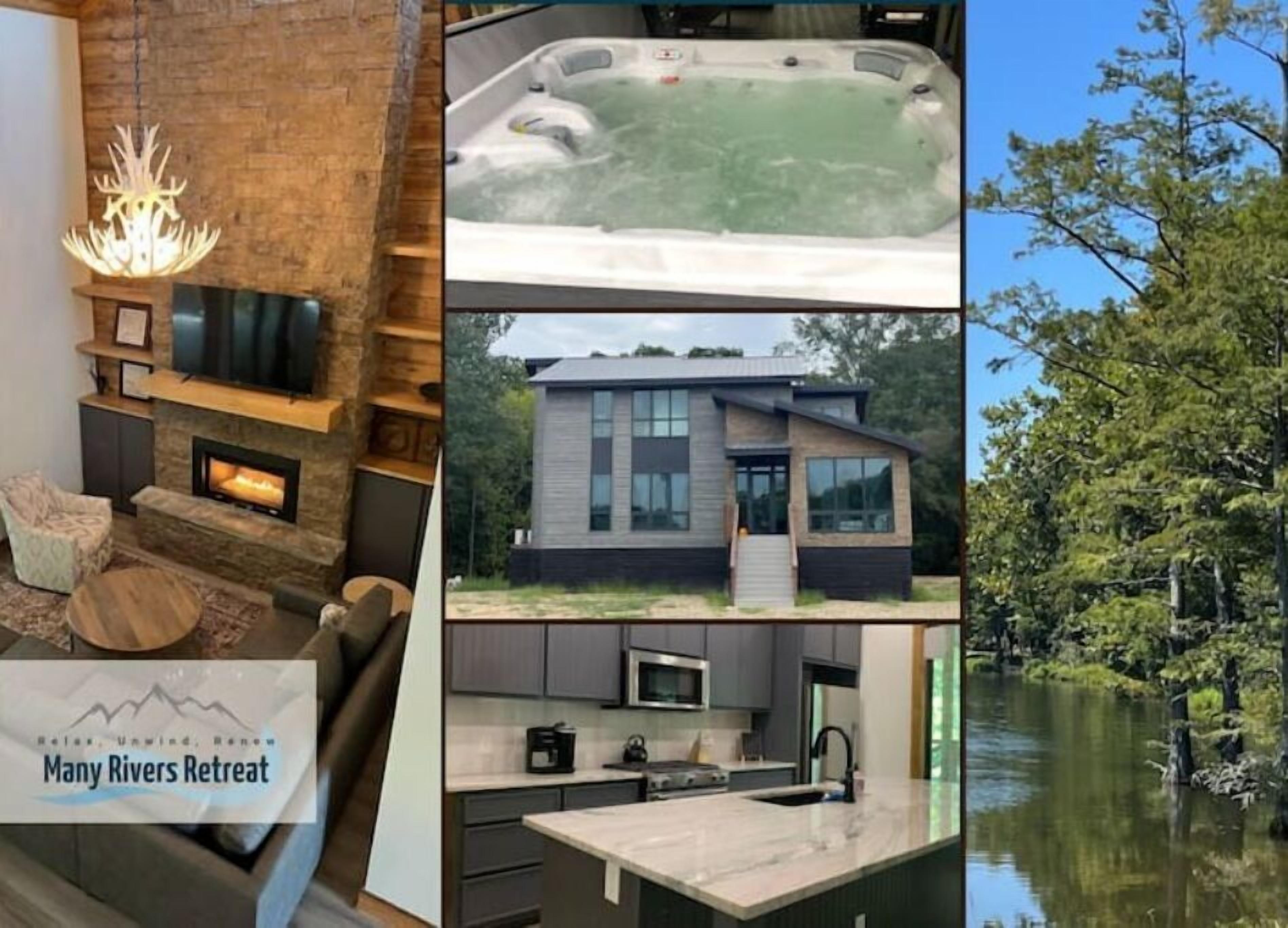 A modern house with a fireplace, a hot tub, and a view of a lake.