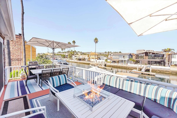 Enjoy your private second floor patio offering a firepit, outdoor dining table and gorgeous bay views.