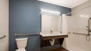 A bathroom with a toilet, sink, and shower.