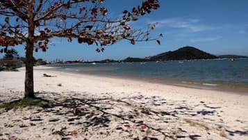 On the beach, white sand, beach umbrellas, beach yoga